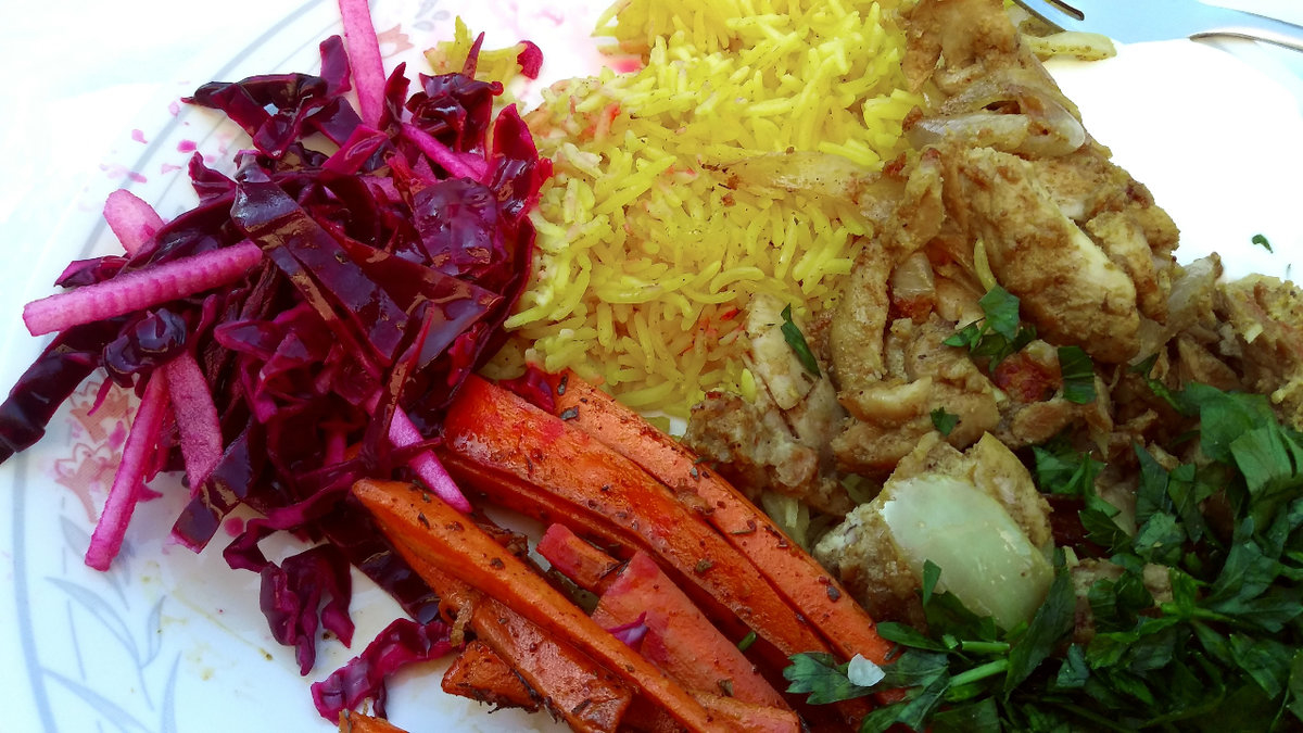 Close up photo of a plate filled with brightly coloured food.
